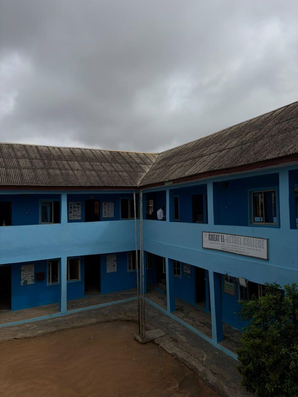 The school's blue two-storey classroom blocks around the courtyard
