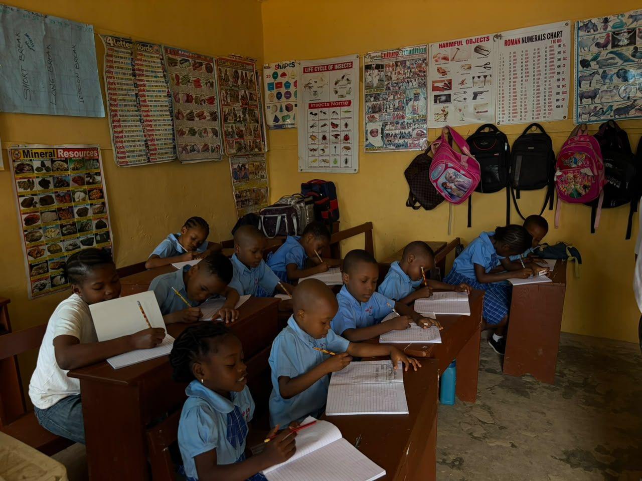 Young pupils writing at their desks