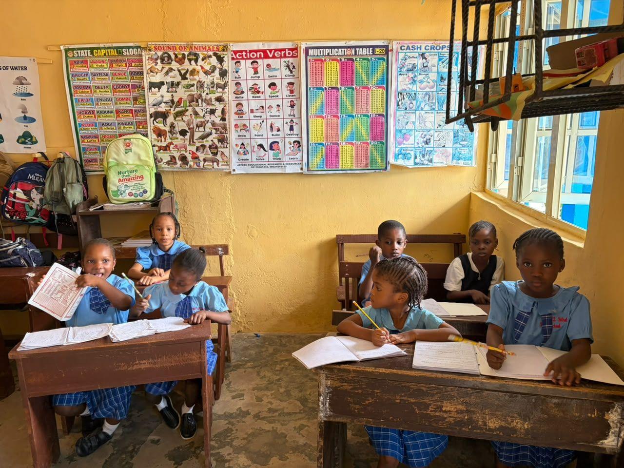 Primary pupils smiling at their desks
